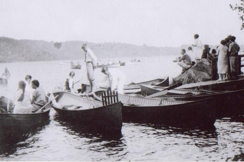 historic picture of canoes and boaters