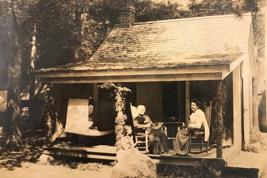 historic picture of guests relaxing on a deck